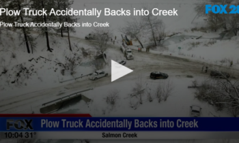 Plow Truck Accidentally Backs into Creek