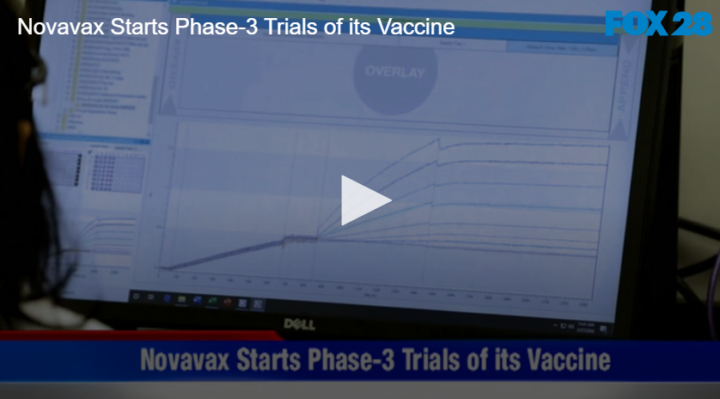 computer monitor with line graph on screen and text reading " Novavax Starts Phase-3 Trials of its Vaccine"