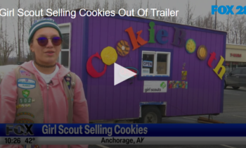 Girl Scout Selling Cookies Out Of Trailer