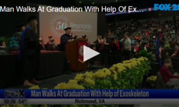 Man Walks at Graduation with Help of Exoskeleton