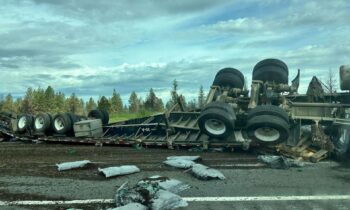 I-90 blocked by semi-truck rollover, spilling soil onto road