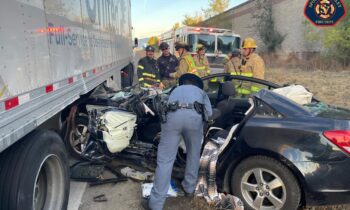 Driver rescued with minor injuries after being pinned under semi-truck on I-90